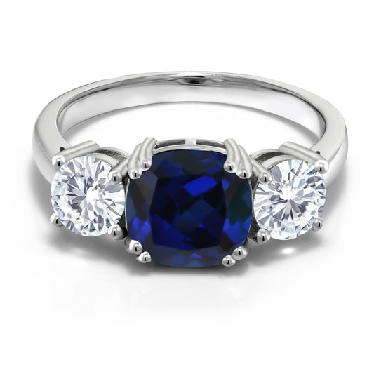 925 Sterling Silver Blue Created Sapphire and Forever Classic Moissanite From Charles & Colvard 3 Stone Engagement Ring For Women (3.50 Cttw, Gemstone September Birthstone, Cushion 8MM, Size 7)