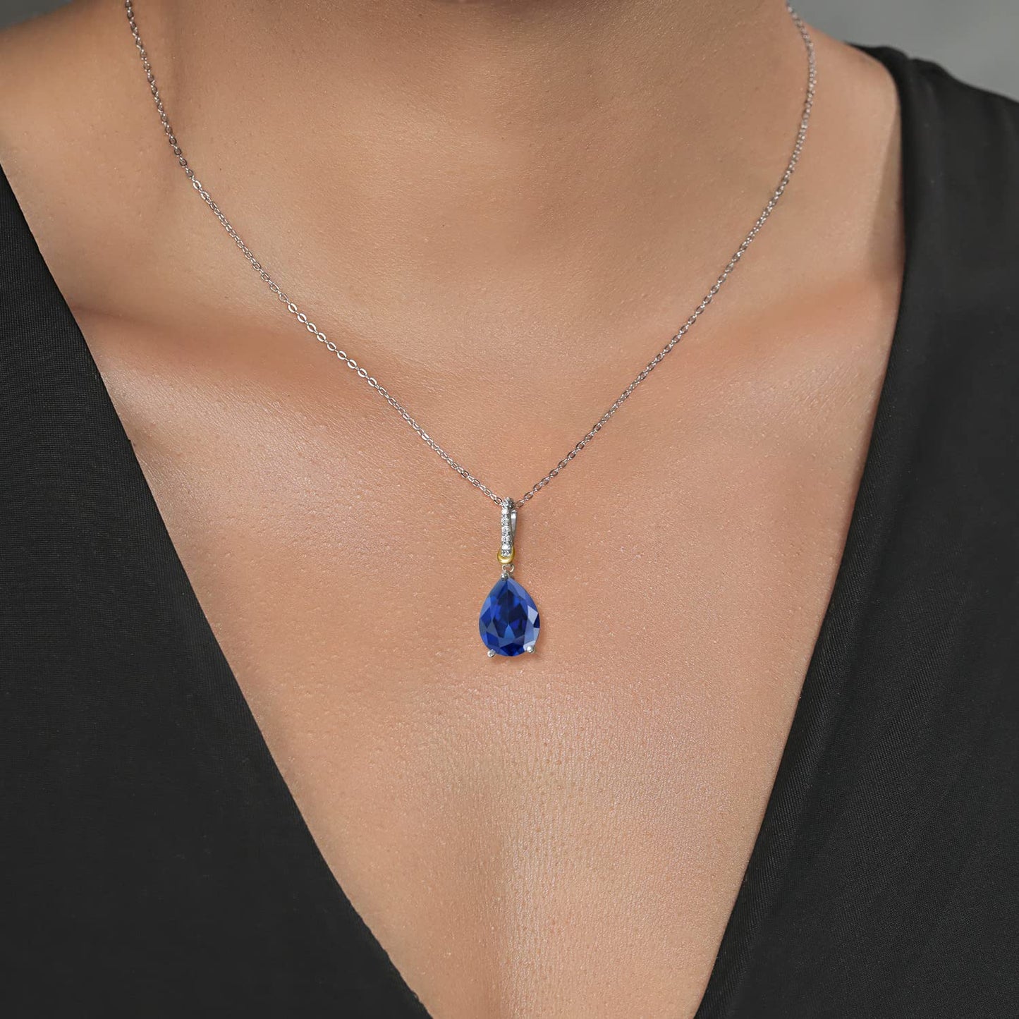 Gem Stone King 925 Sterling Silver and 10K Yellow Gold Pear Shape Blue Simulated Sapphire and White Moissanite Pendant Necklace For Women (10.26 Cttw with 18 Inch Chain)